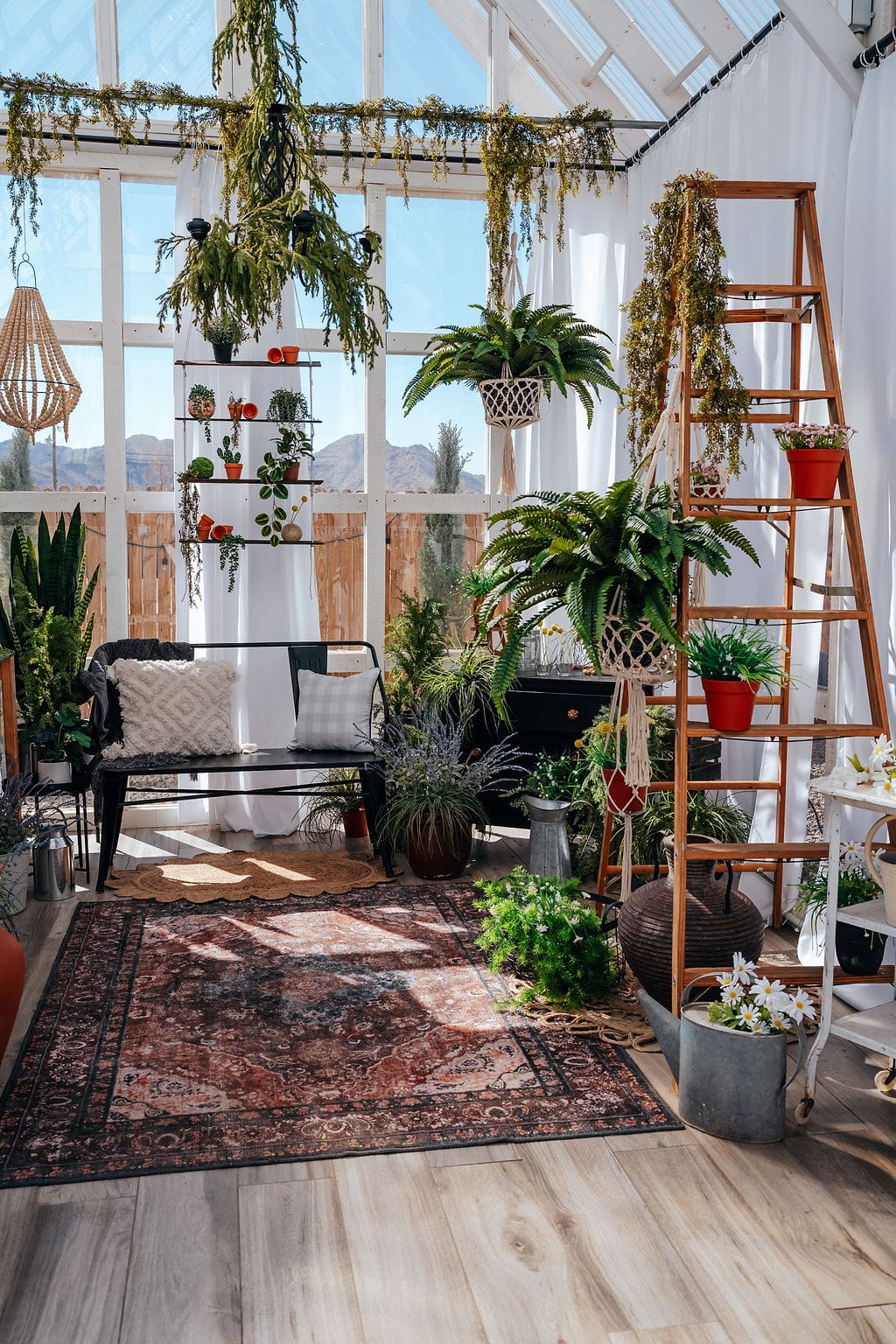 A room filled with lots of plants and furniture.