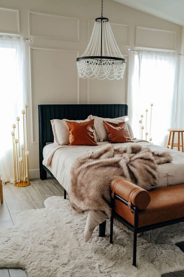 A bedroom with a bed, chair and window.