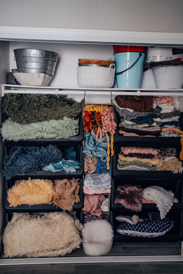 A shelf filled with different types of fabrics.