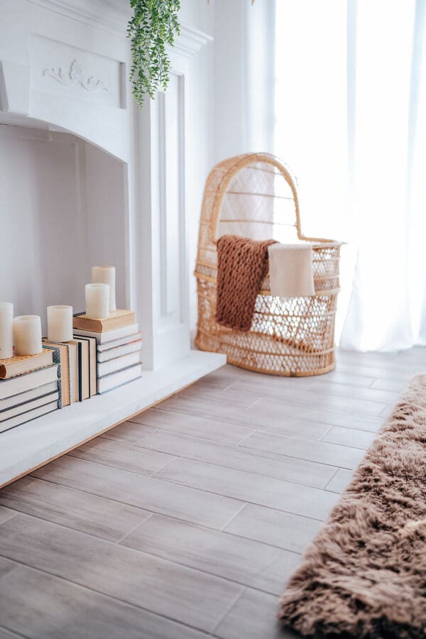 A wicker chair in the corner of a room.
