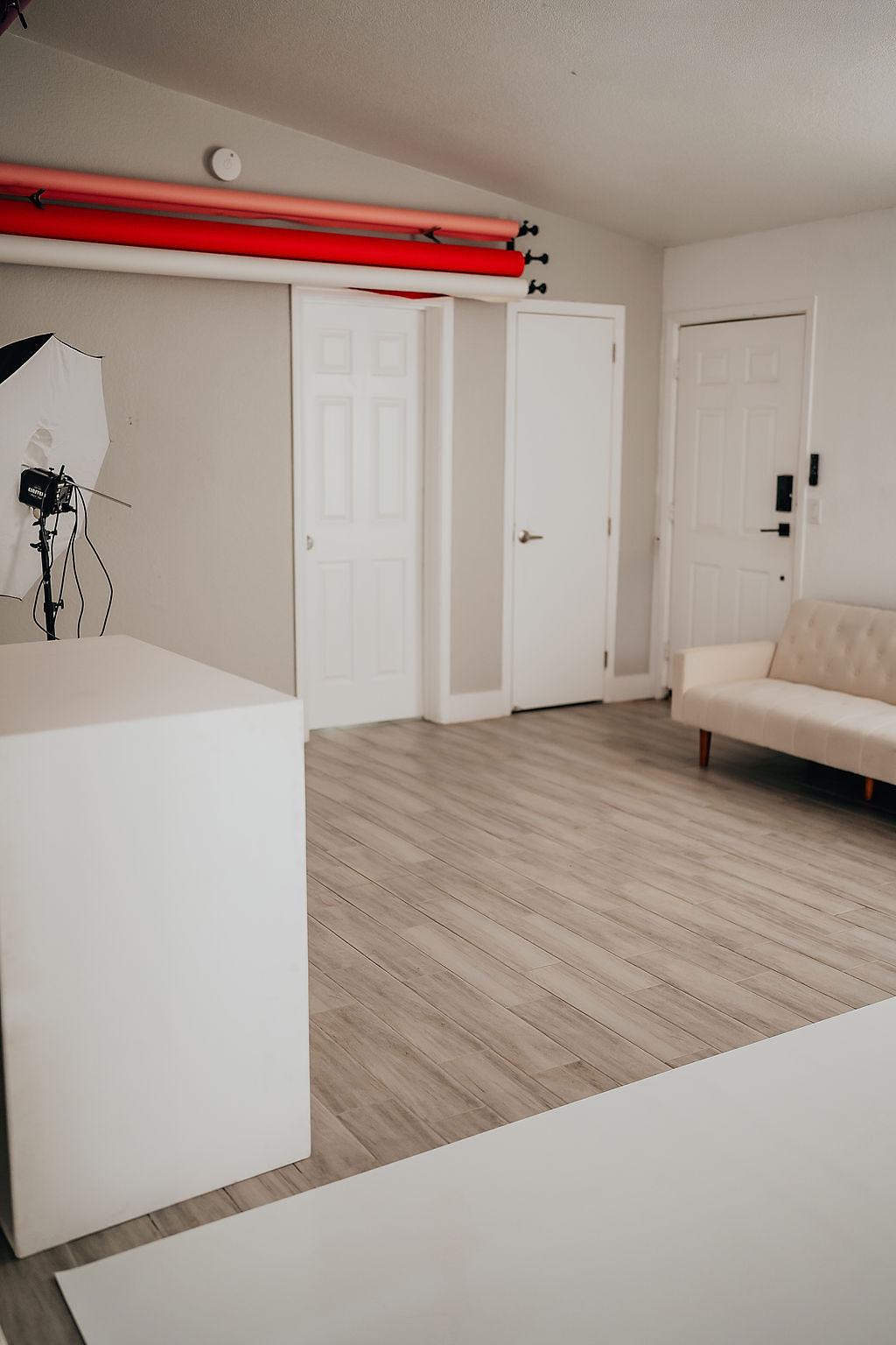 A room with white walls and wooden floors.