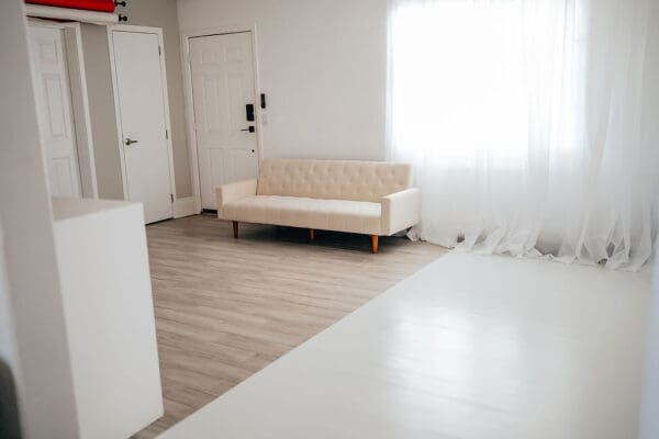A white couch sitting in the middle of a room.