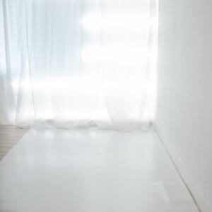 Bright room with sheer white curtains.