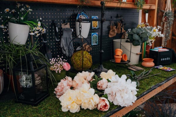 A table with flowers and other items on it.