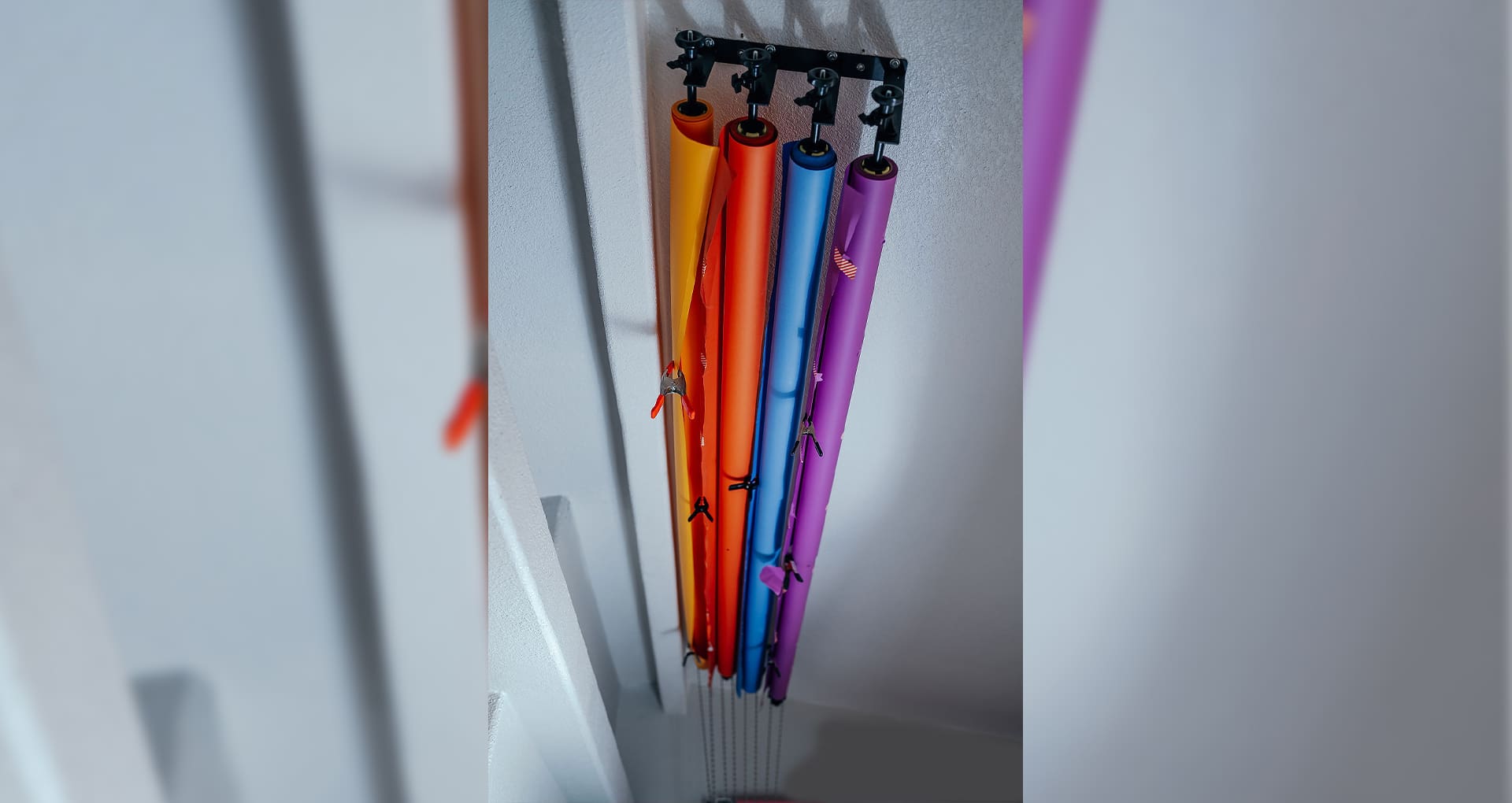 A bunch of colored pencils hanging from the ceiling