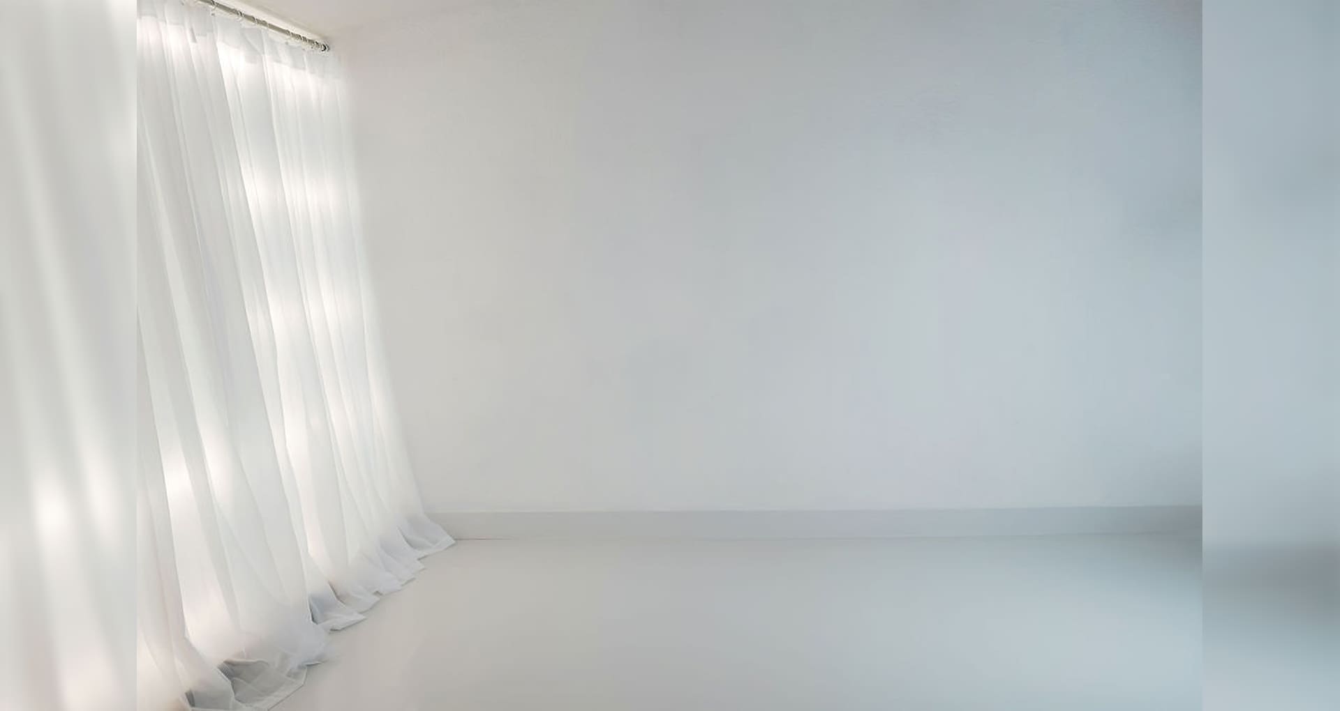 A white room with a curtain and a light