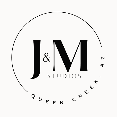 A black and white logo of j & m studios.